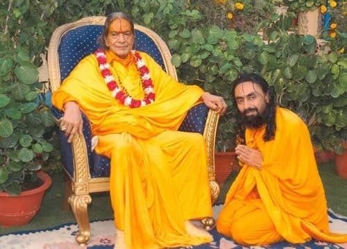 SWAMI MUKUNDANANDA AT THE LOTUS FEET OF HIS SPIRITUAL MASTER