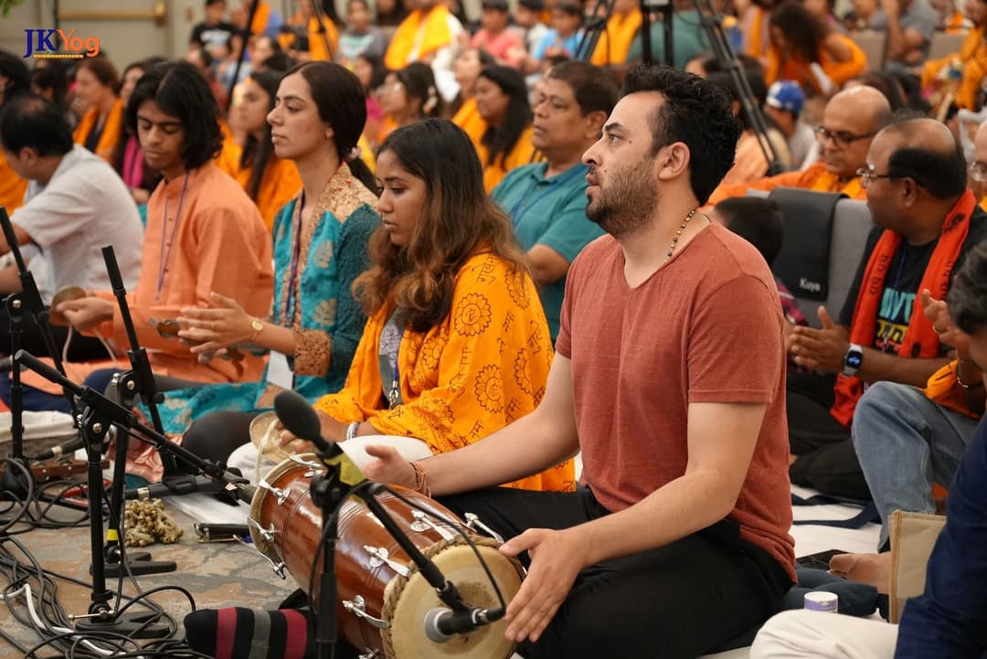 Musicians immersed in soulful devotional music, playing traditional instruments and creating an uplifting atmosphere at Swamiji's Life Transformation Program in the USA.
