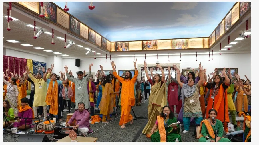 Devotees immersed in joyful kirtan, celebrating Holi through music, devotion, and collective spiritual upliftment