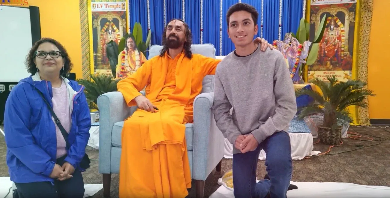 Participant meeting Swamiji during a personal interaction session, experiencing a moment of connection and guidance.