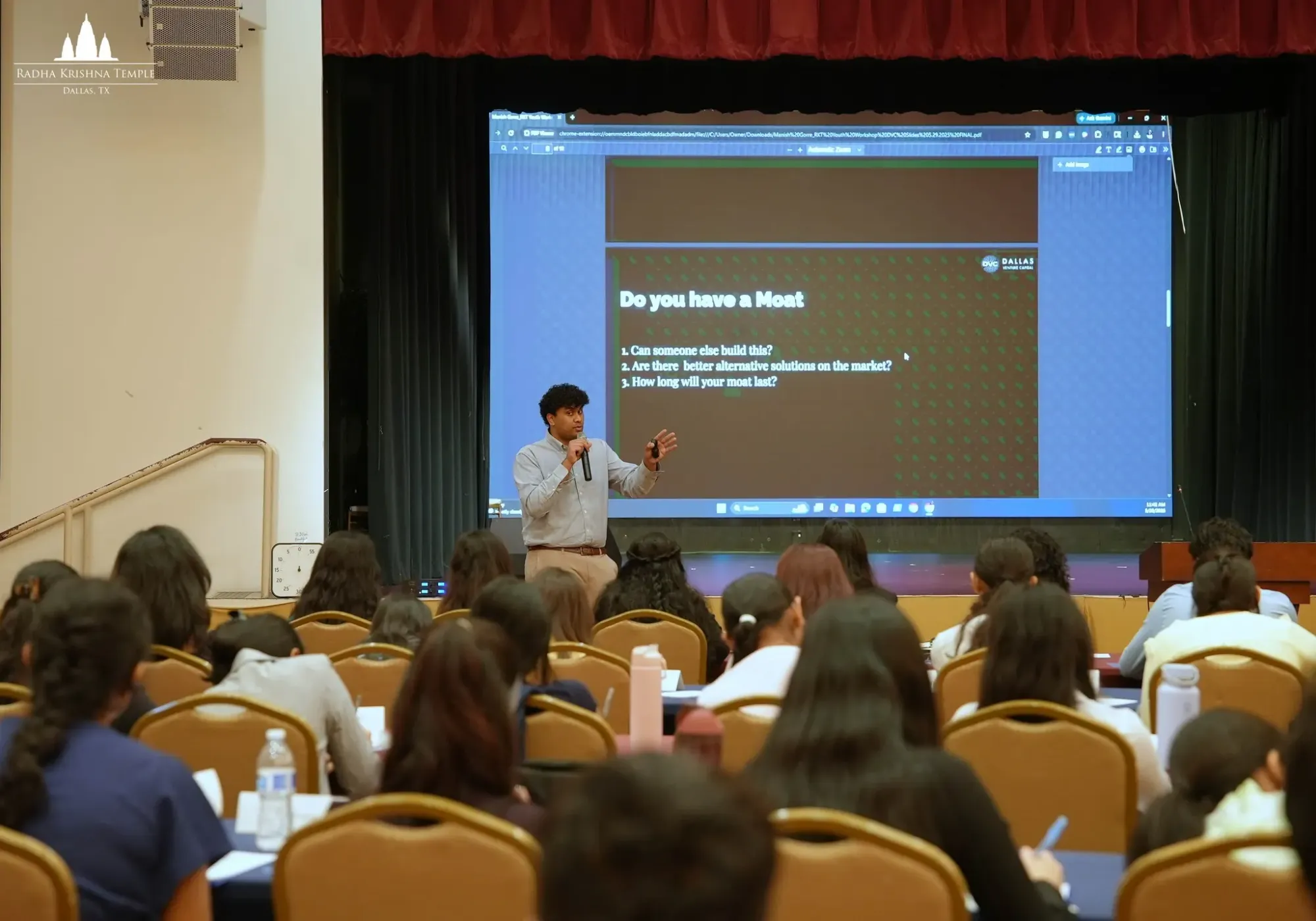 Speaker presents a “Do You Have a Moat?” slide to students during the 2026 Youth Leadership Workshop at Radha Krishna Temple Dallas.
