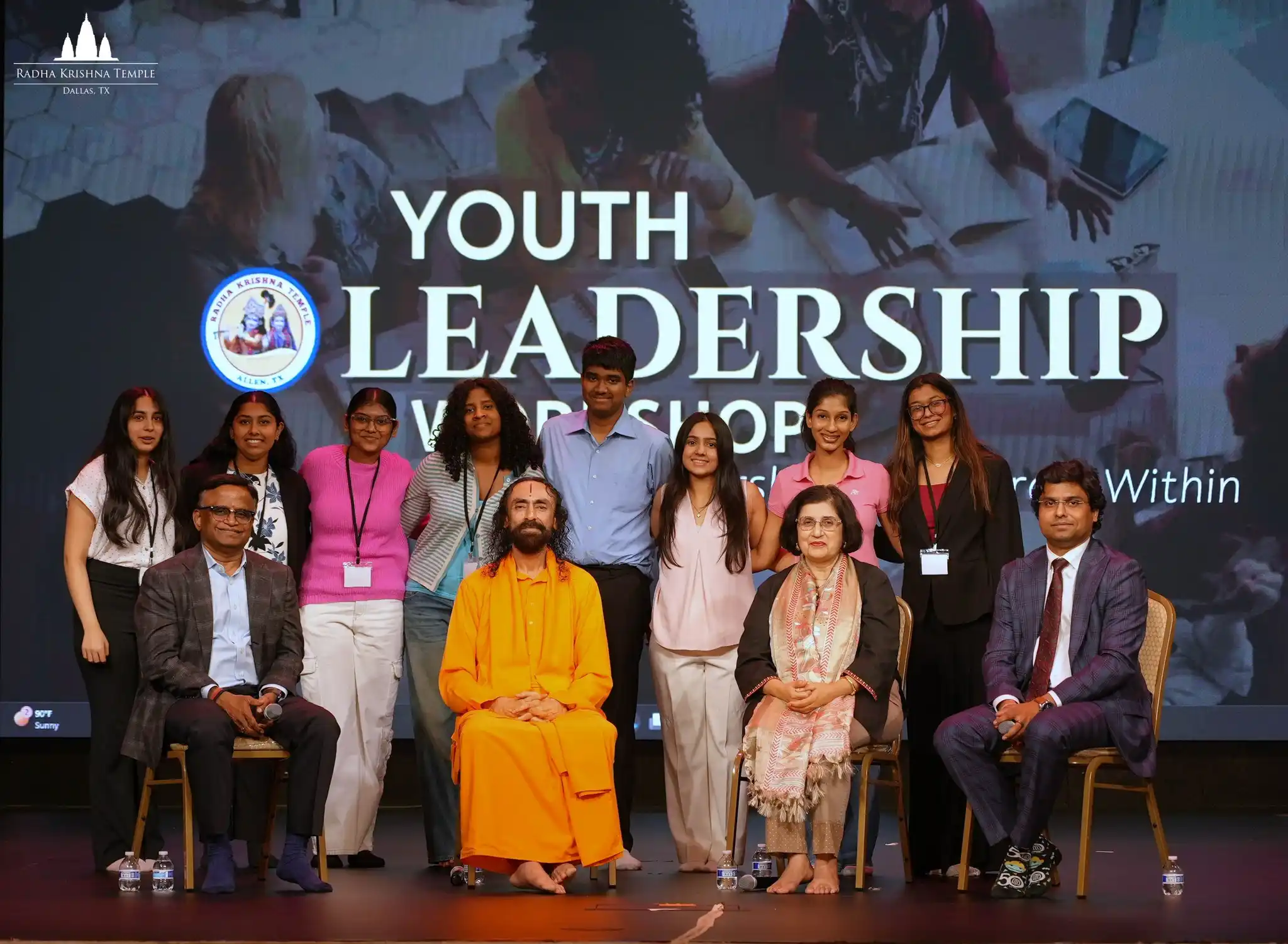 Group photo of students, mentors, and Swami Mukundananda on stage during the 2026 Youth Leadership Workshop.