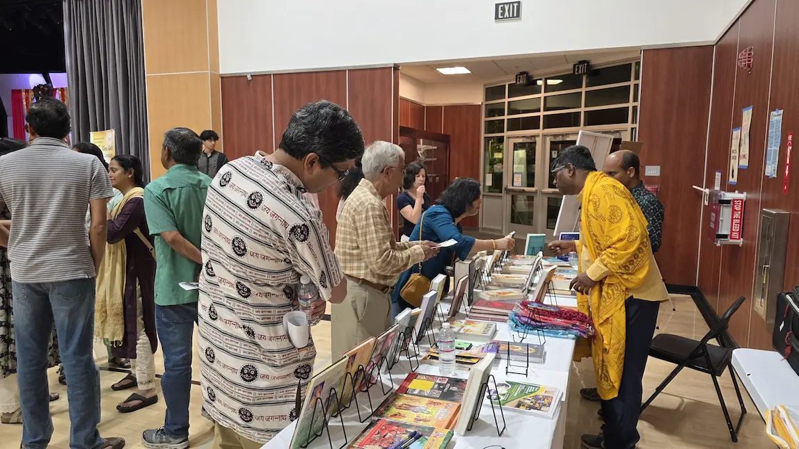 Attendees browsing books after Swamiji discourse