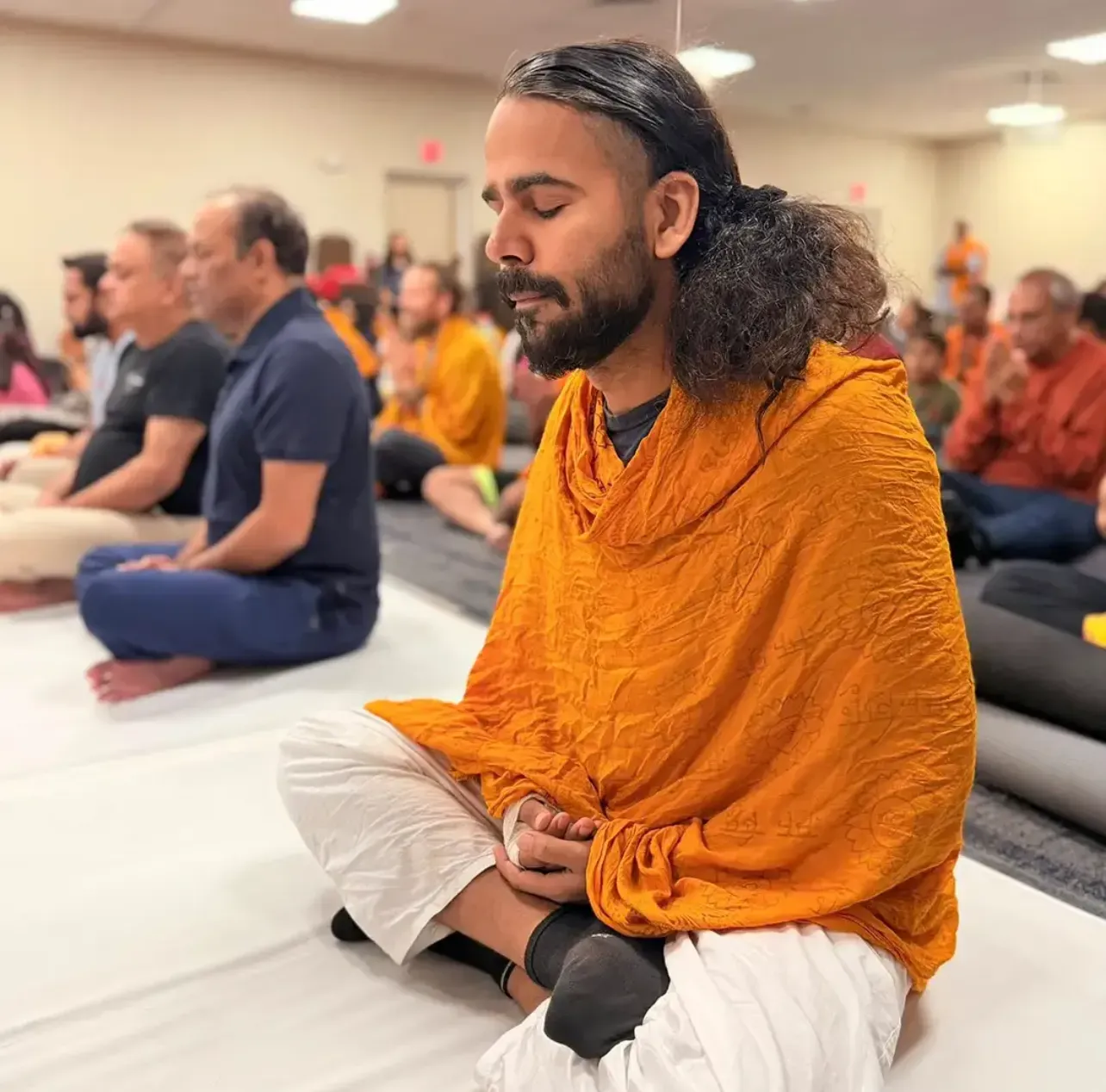 An attendee engaging in yoga and meditation