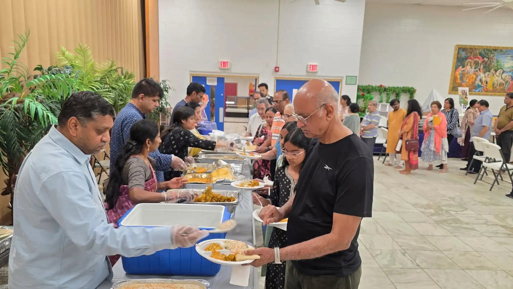 Volunteers serving prasad to devotees at the Connecticut Life Transformation Program.https://a.co/d/0i6hieuC